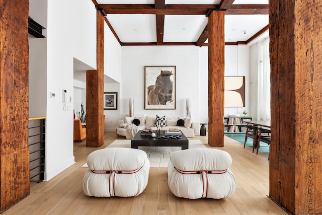 62 Beach St Tha, Unit Tha, New York City, NY 10013 - living area featuring light wood-type flooring, beamed ceiling, a high ceiling, and ornate columns