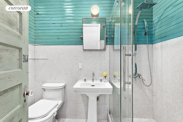 full bath featuring tile walls, toilet, and a stall shower