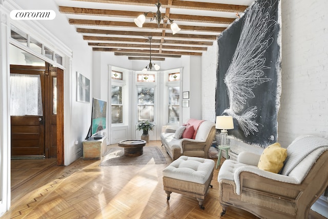 living area featuring a notable chandelier, beam ceiling, visible vents, and plenty of natural light