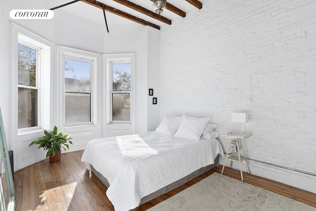 bedroom featuring wood-type flooring, visible vents, beam ceiling, and brick wall
