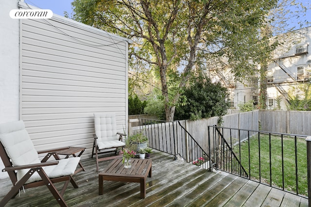wooden deck featuring a yard and a fenced backyard