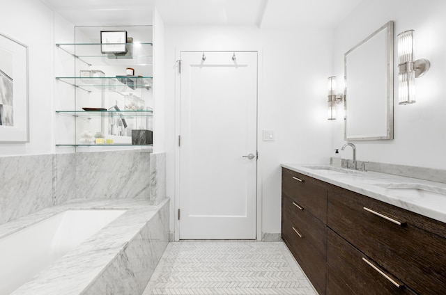 44 Laight St Unit 6C, New York City, NY 10013 - full bathroom featuring a tub with marble appearance, double vanity, and tile patterned floors