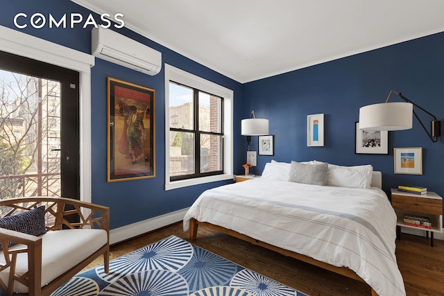 bedroom with baseboards, a wall unit AC, baseboard heating, and ornamental molding