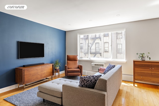416 E 11th St Unit 4A, New York City, NY 10009 - living room with wood finished floors, baseboards, a wall mounted air conditioner, and recessed lighting