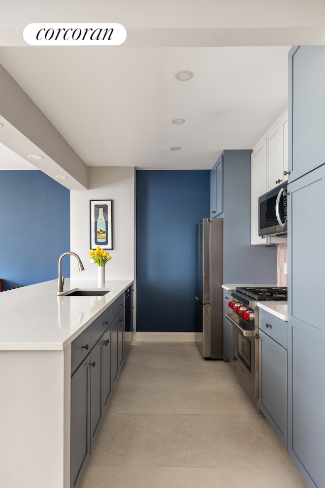 416 E 11th St Unit 4A, New York City, NY 10009 - kitchen featuring appliances with stainless steel finishes, a sink, finished concrete floors, a peninsula, and light countertops