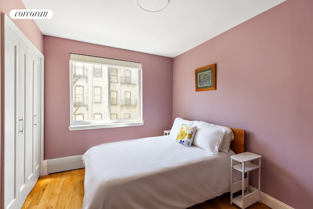 416 E 11th St Unit 4A, New York City, NY 10009 - bedroom with wood finished floors and baseboards