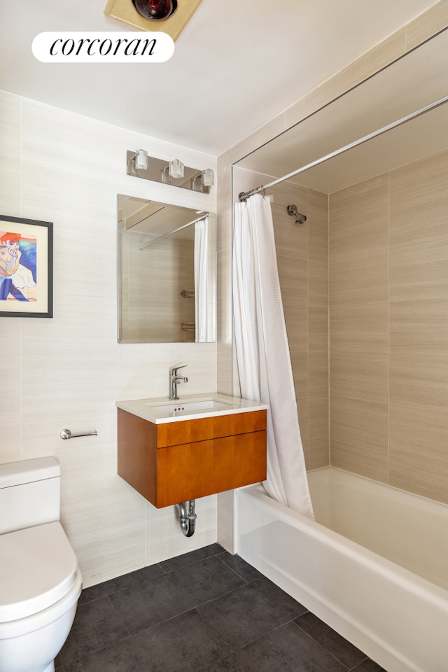 416 E 11th St Unit 4A, New York City, NY 10009 - bathroom with tile patterned floors, toilet, shower / tub combo with curtain, and tile walls