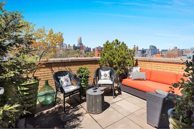 view of patio / terrace featuring a view of skyline and outdoor lounge area