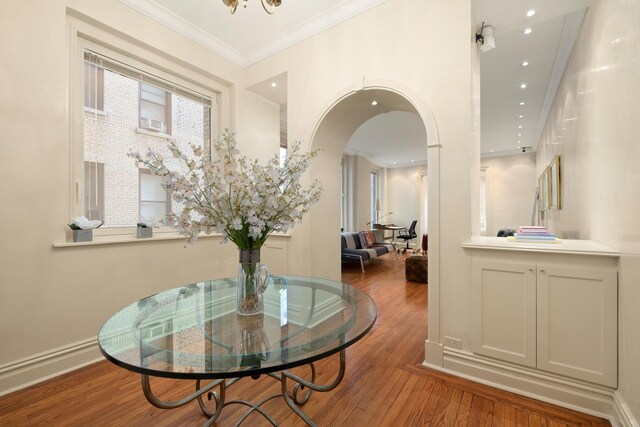 470 Park Ave Unit 4D, New York City, NY 10022 - dining room with wood finished floors, arched walkways, ornamental molding, and recessed lighting