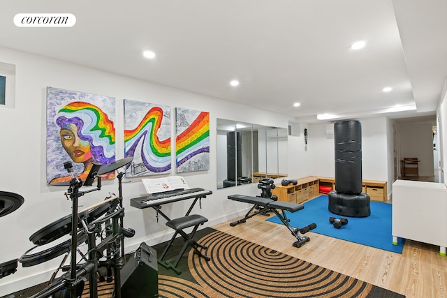 workout room with wood finished floors and recessed lighting