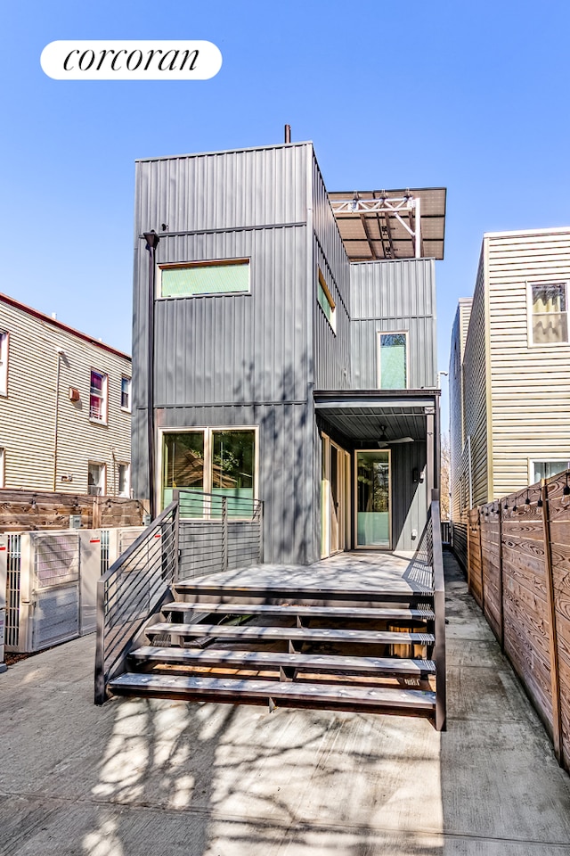 back of house featuring fence and board and batten siding