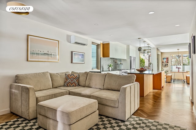 living area featuring a wall unit AC, recessed lighting, and baseboards