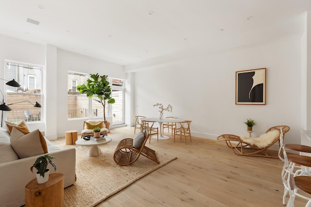 living area with light wood-style floors and baseboards