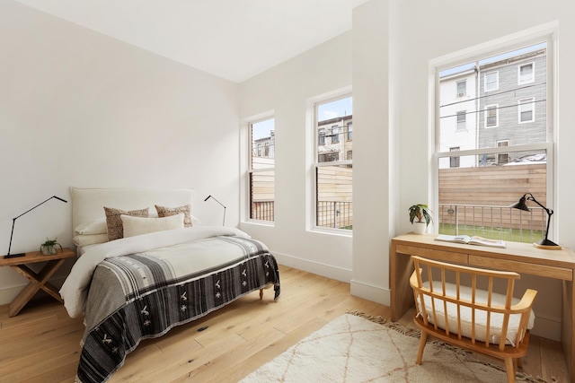 bedroom with baseboards and wood finished floors