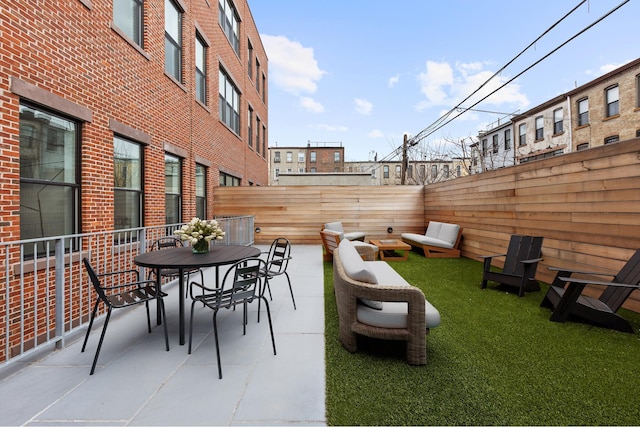 view of patio featuring outdoor dining area and a fenced backyard