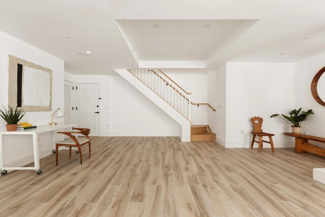interior space with baseboards, light wood-style flooring, stairs, and recessed lighting
