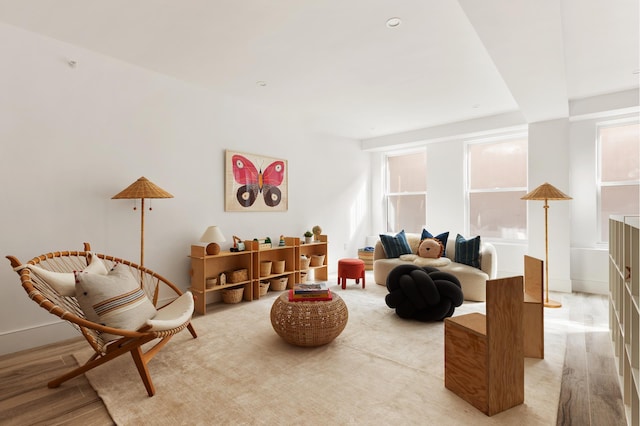 living area featuring light wood-type flooring and baseboards