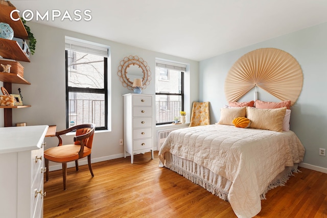 bedroom featuring light wood-type flooring and baseboards