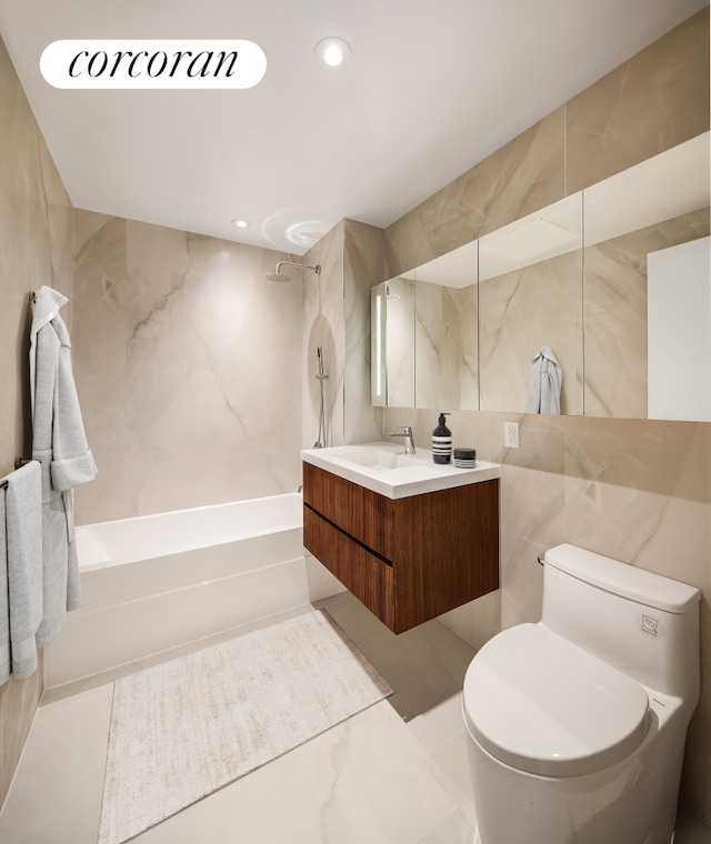 bathroom with tile walls, toilet, vanity, tub / shower combination, and recessed lighting