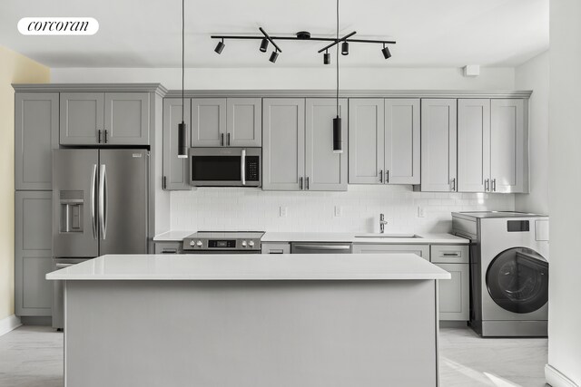 880 W 181st St Unit 4C, New York City, NY 10033 - kitchen with appliances with stainless steel finishes, washer / clothes dryer, gray cabinets, light countertops, and backsplash