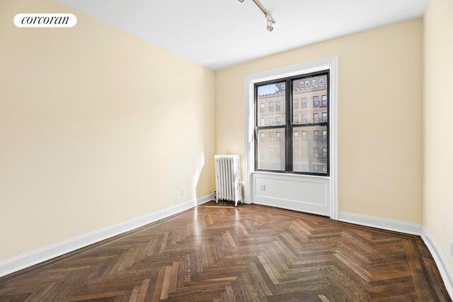 880 W 181st St Unit 4C, New York City, NY 10033 - spare room with radiator and track lighting