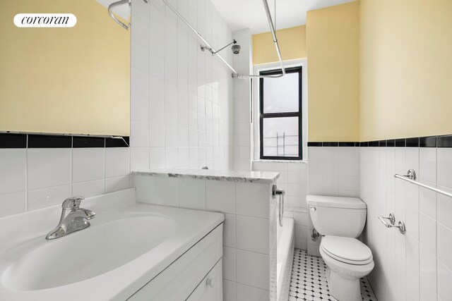 880 W 181st St Unit 4C, New York City, NY 10033 - full bath featuring tile walls, vanity, bathing tub / shower combination, tile patterned flooring, and a wainscoted wall