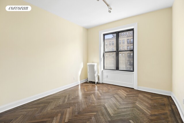880 W 181st St Unit 4C, New York City, NY 10033 - empty room with radiator and rail lighting