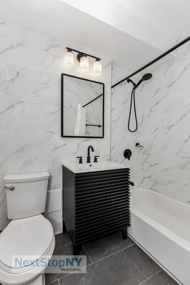 310 E 49th St Unit 2J, New York City, NY 10017 - bathroom with toilet, vanity, washtub / shower combination, and tile walls