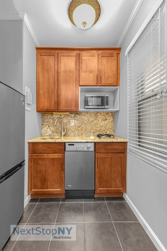 310 E 49th St Unit 2J, New York City, NY 10017 - kitchen with appliances with stainless steel finishes, crown molding, a sink, decorative backsplash, and light stone countertops