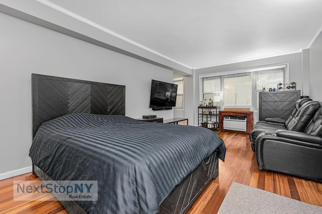 310 E 49th St Unit 2J, New York City, NY 10017 - bedroom featuring ornamental molding, wood finished floors, and baseboards
