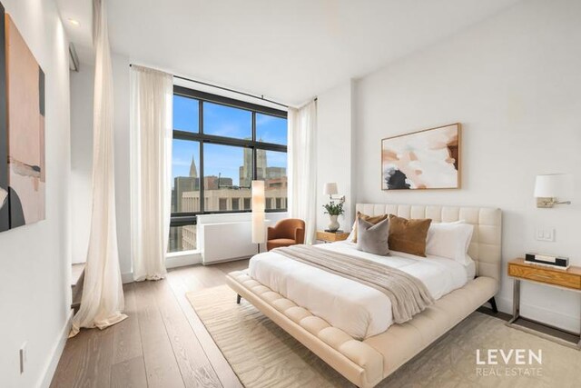 235 E 55th St Phb, Phb, New York City, NY 10022 - bedroom with hardwood / wood-style flooring and a wall of windows