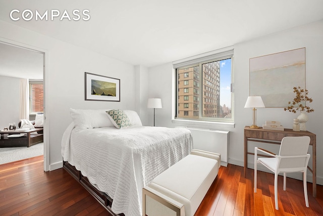 206 E 95th St Unit 10B, New York City, NY 10128 - bedroom with multiple windows, hardwood / wood-style floors, and baseboards