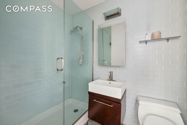 206 E 95th St Unit 10B, New York City, NY 10128 - full bath with tile walls, vanity, a stall shower, and toilet