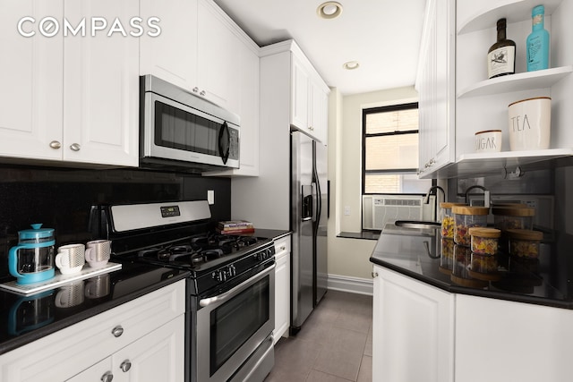 801 Riverside Dr Unit 4B, New York City, NY 10032 - kitchen featuring stainless steel appliances, open shelves, dark countertops, white cabinets, and recessed lighting