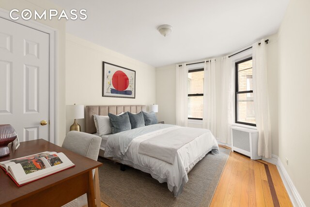 801 Riverside Dr Unit 4B, New York City, NY 10032 - bedroom featuring radiator heating unit, light wood-style flooring, and baseboards