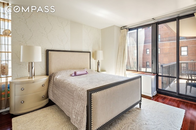 304 E 65th St Unit 10D, New York City, NY 10065 - bedroom featuring hardwood / wood-style floors, access to outside, multiple windows, an accent wall, and floor to ceiling windows