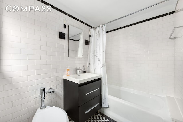 470 W 24th St Unit 2C, New York City, NY 10011 - bathroom featuring tile walls, vanity, shower / bath combo with shower curtain, and tile patterned floors