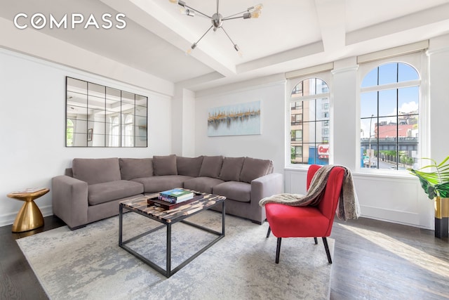 470 W 24th St Unit 2C, New York City, NY 10011 - living room featuring wood finished floors, a chandelier, baseboards, and beam ceiling