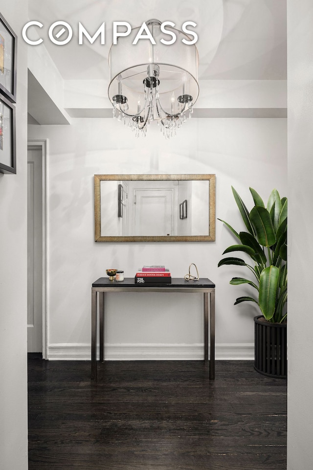 470 W 24th St Unit 2C, New York City, NY 10011 - hall with a chandelier, wood finished floors, and baseboards