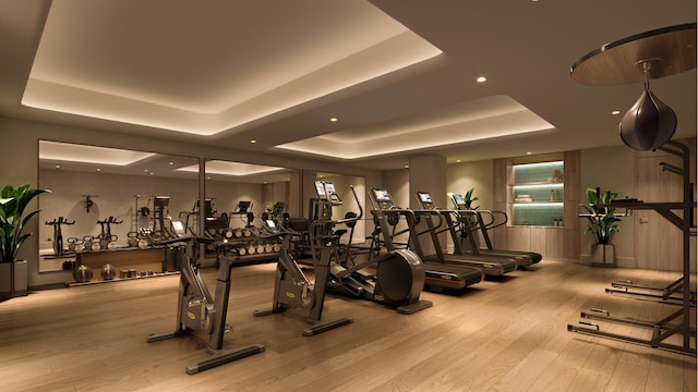 499 9th Ave Unit 9Dn, New York City, NY 10018 - exercise room featuring a tray ceiling, wood finished floors, and recessed lighting
