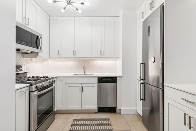7 E 14th St Unit 1528, New York City, NY 10003 - kitchen featuring appliances with stainless steel finishes, a sink, light countertops, and tasteful backsplash