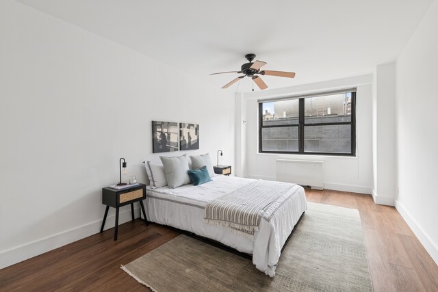 7 E 14th St Unit 1528, New York City, NY 10003 - bedroom with wood finished floors, radiator heating unit, and ceiling fan