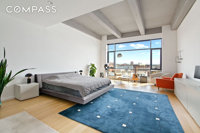 160 Imlay St Unit 4E2, New York City, NY 11231 - bedroom with beamed ceiling, wood finished floors, and access to outside