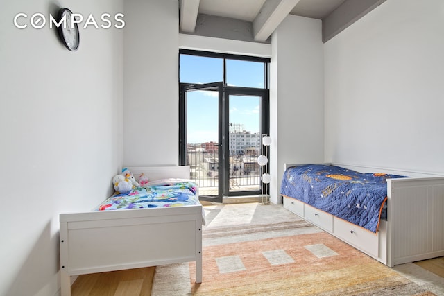 160 Imlay St Unit 4E2, New York City, NY 11231 - bedroom with beamed ceiling, access to outside, wood finished floors, and a view of city