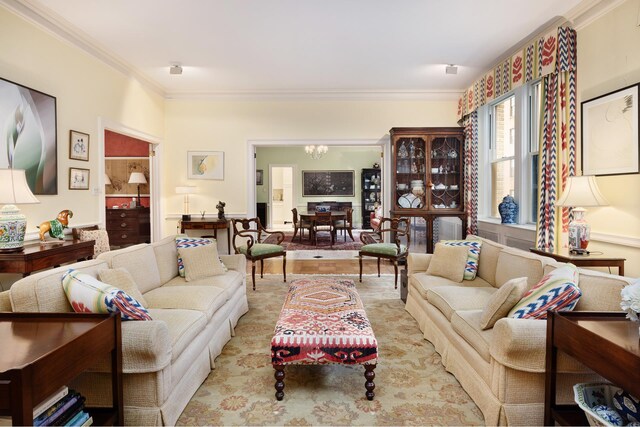 living area with a chandelier and ornamental molding
