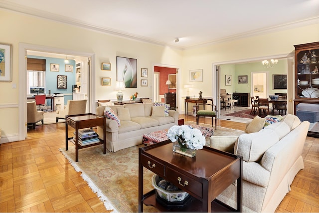 living area featuring a chandelier, ornamental molding, and a desk