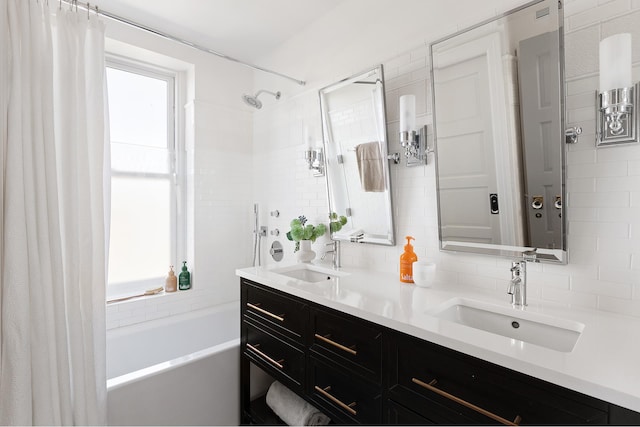 full bathroom featuring tasteful backsplash, a sink, and double vanity