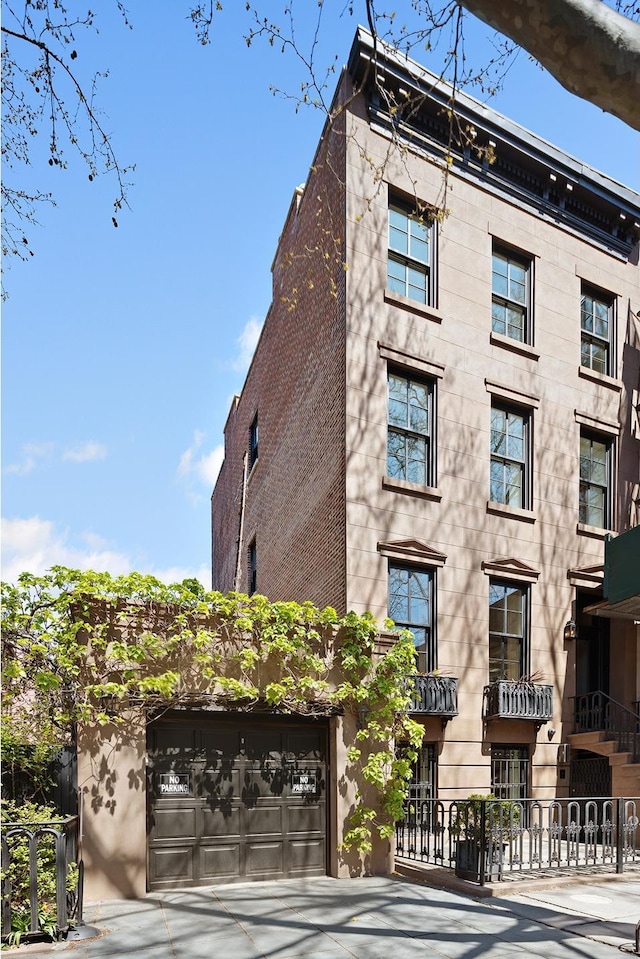 view of building exterior featuring concrete driveway