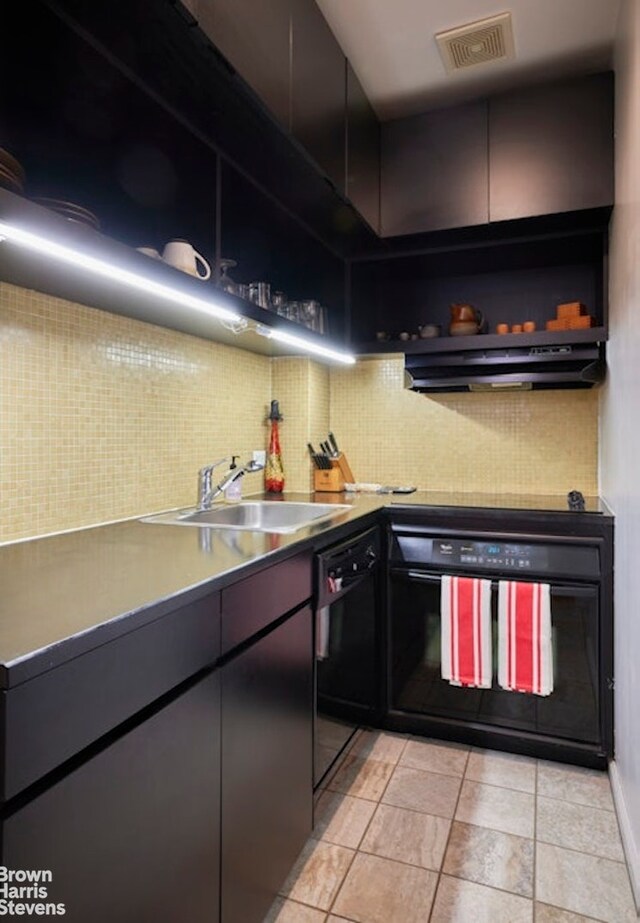 56 Pine St Unit 3B, New York City, NY 10005 - kitchen with a sink, black appliances, under cabinet range hood, tasteful backsplash, and light tile patterned floors