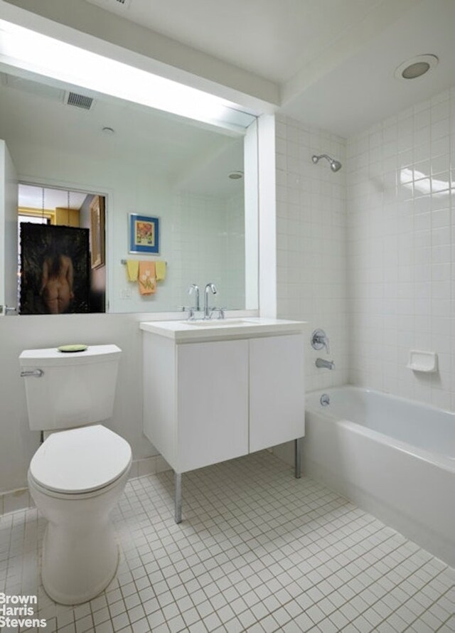56 Pine St Unit 3B, New York City, NY 10005 - bathroom featuring tile patterned floors, toilet, vanity, and bathing tub / shower combination